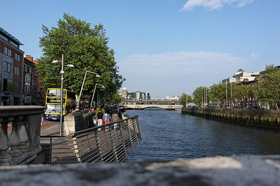 Dublin’s River Liffey, tree-lined boardwalk and historic city buildings